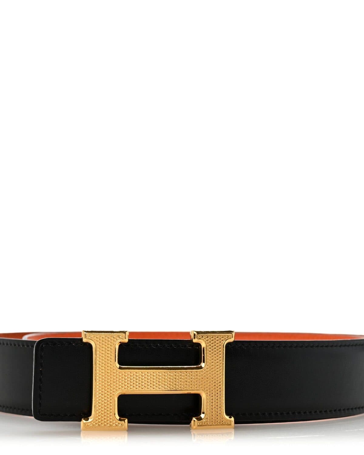 Reversible leather belt photographed on a neutral ground