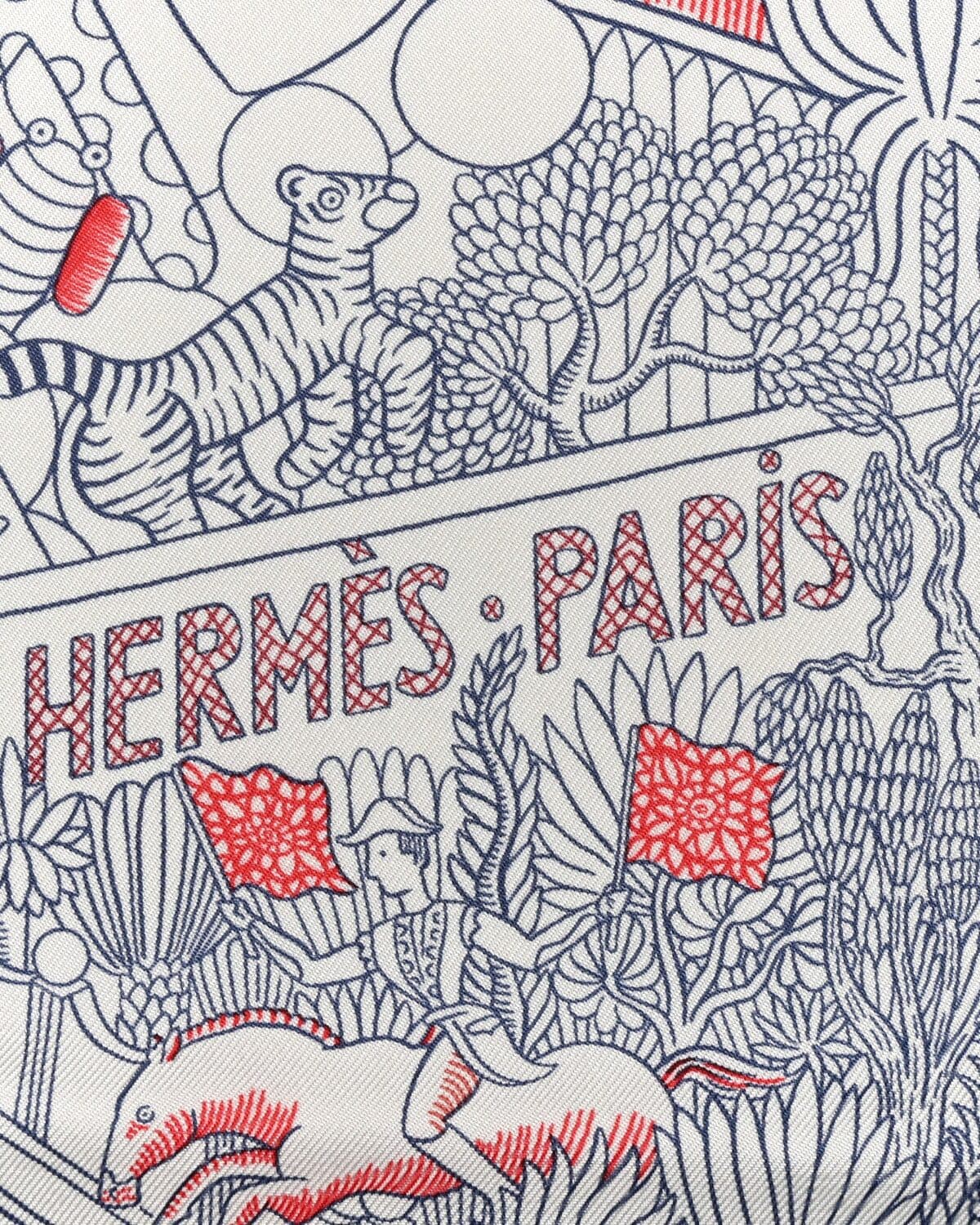 An Hermès silk carré printed HERMÈS·PARIS in blue and red on ivory