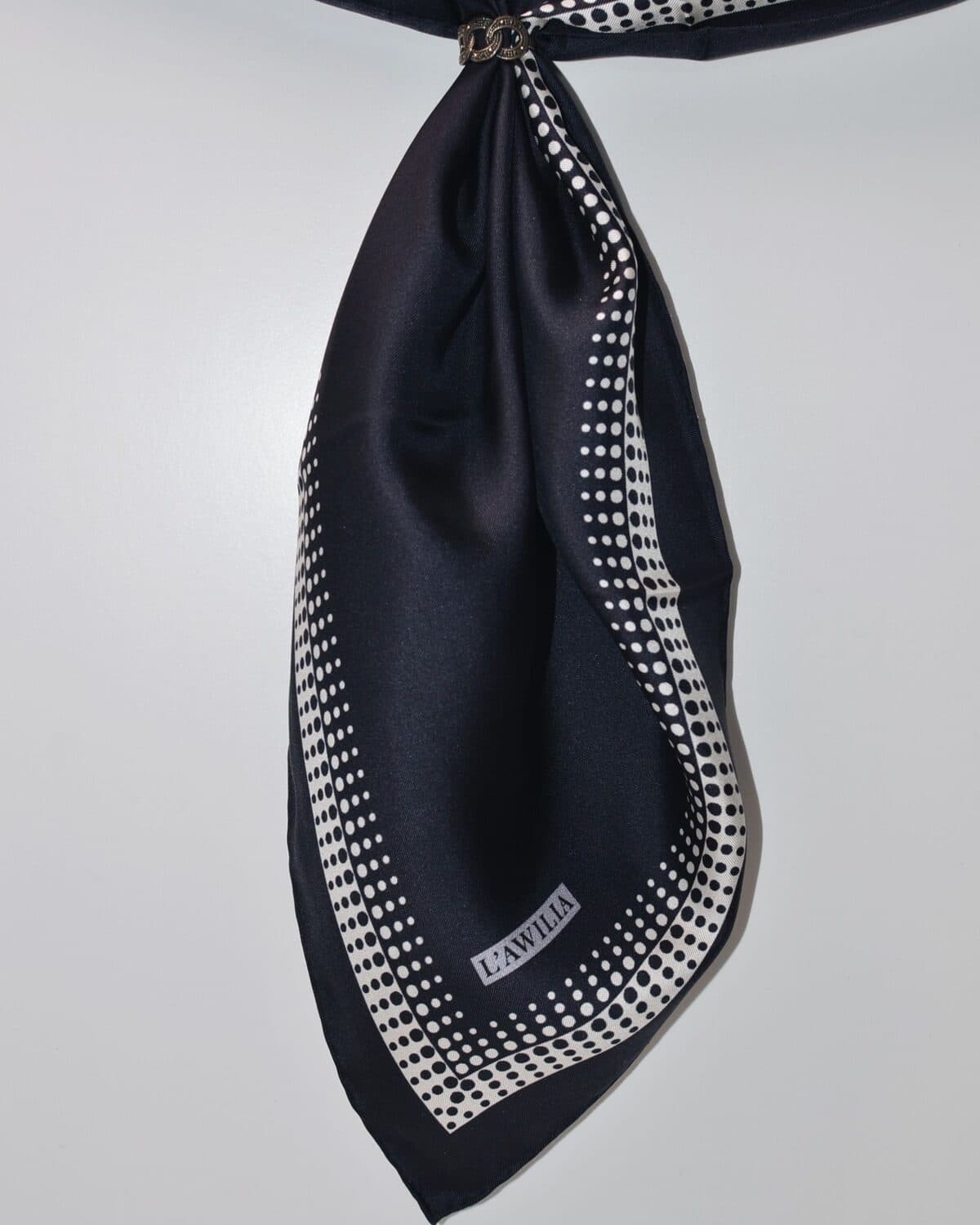 Fringed wool wrap photographed on a neutral ground