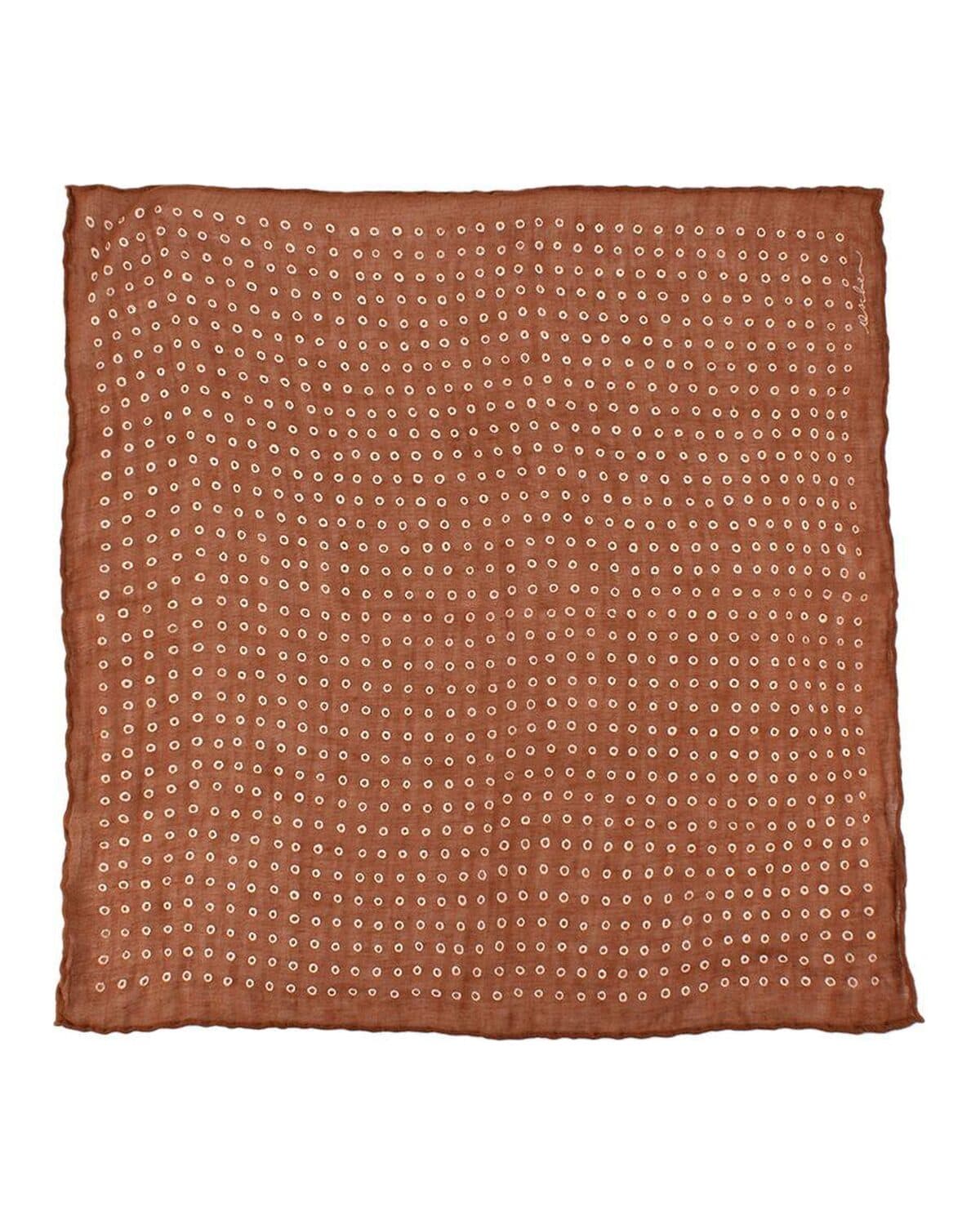 Dotted silk pocket square photographed on a neutral ground